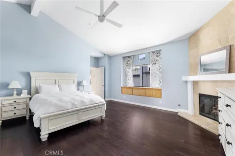 a spacious bedroom with a bed and a fireplace