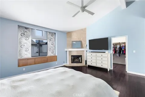 a bedroom with furniture fireplace and flat screen tv