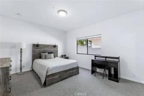 a bedroom with a bed and a desk