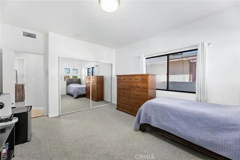 a bedroom with a bed and a mirror