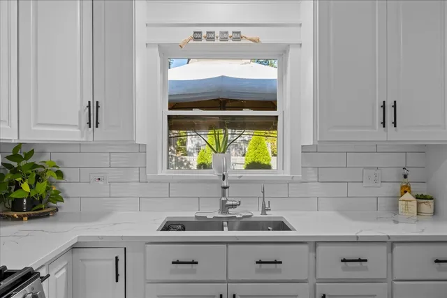 a kitchen with a sink and window