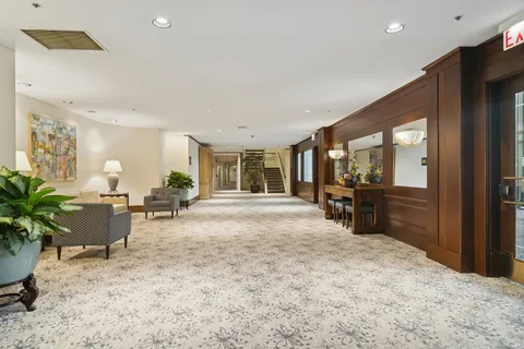 a view of a patio with dining table and chairs with a fire pit and a large tree