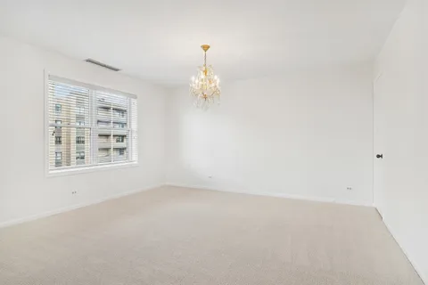 an empty room with a fireplace and window