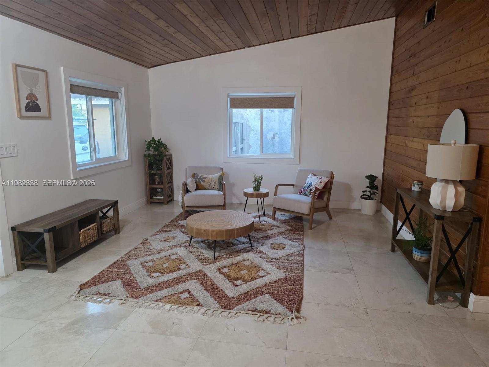 14530 Southwest 110th Street Miami, FL 33186 - Photo 5 of 45 a living room with furniture a rug and a window