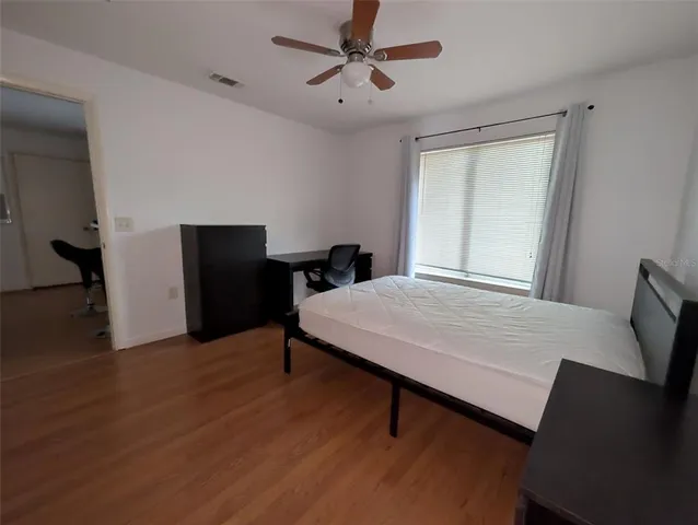 a room with furniture pool table and wooden floor