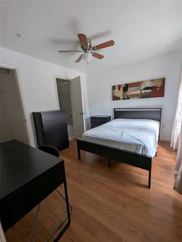 a bedroom with furniture and wooden floor