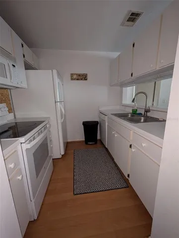 a kitchen with a sink and a stove top oven