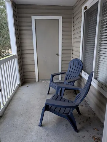 a view of a two chairs in the balcony