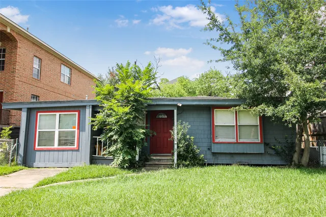 a house that has a tree in front of it