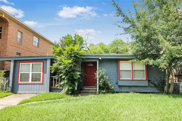 a house that has a tree in front of it