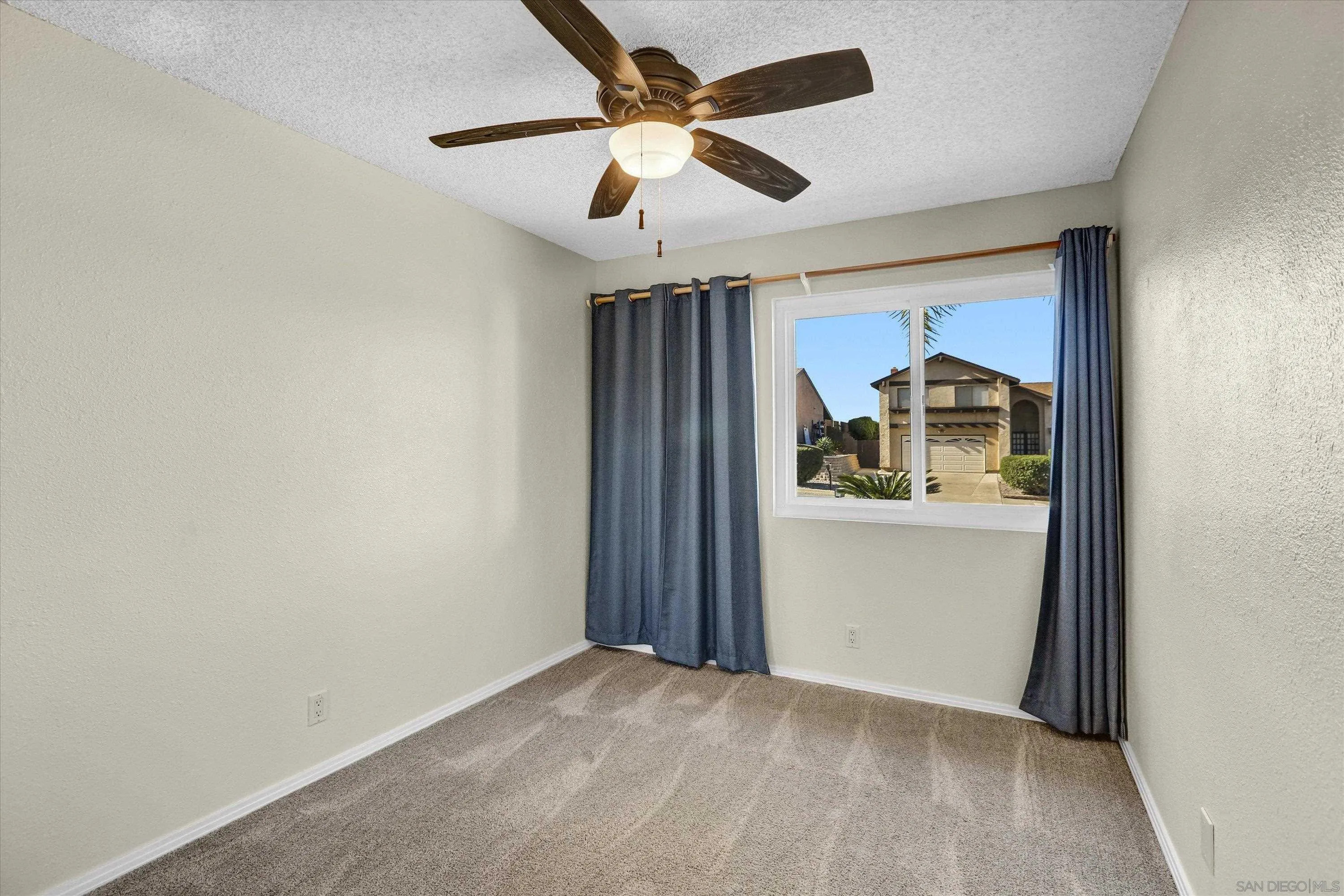 9448 Palomino Ridge Drive Lakeside, CA 92040 - Photo 16 of 35 an empty room with chandelier fan