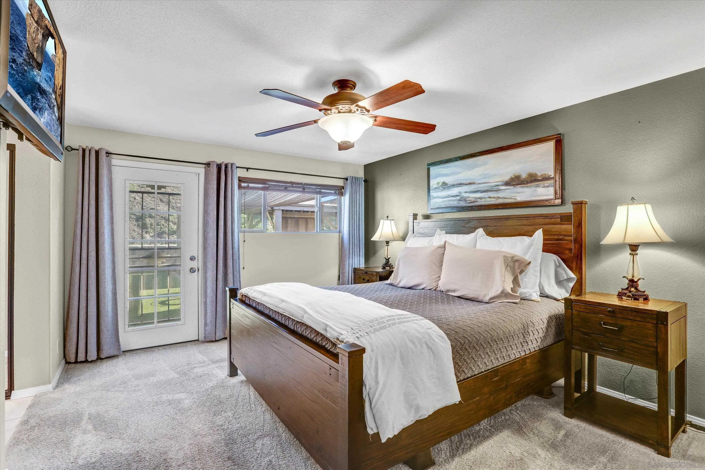 9448 Palomino Ridge Drive Lakeside, CA 92040 - Photo 20 of 35 a bedroom with a bed and a chandelier