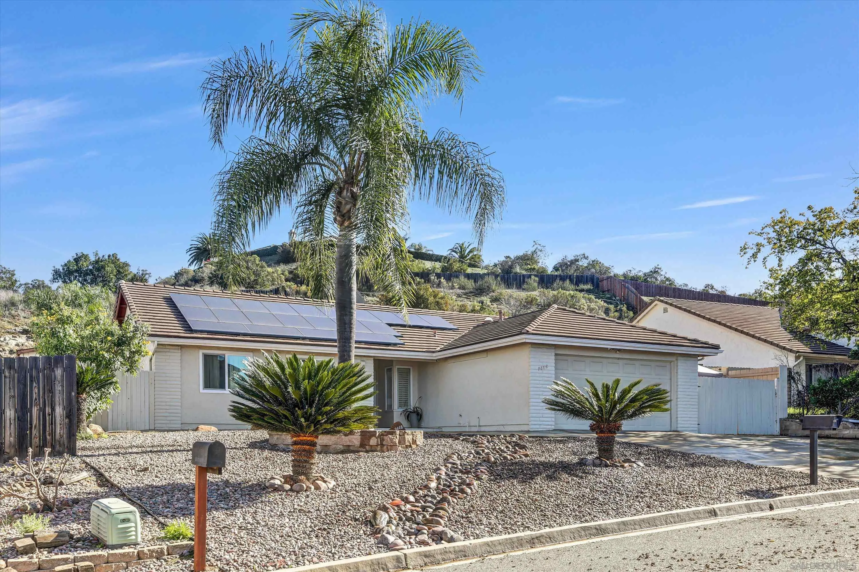 9448 Palomino Ridge Drive Lakeside, CA 92040 - Photo 2 of 35 a front view of a house with a garden