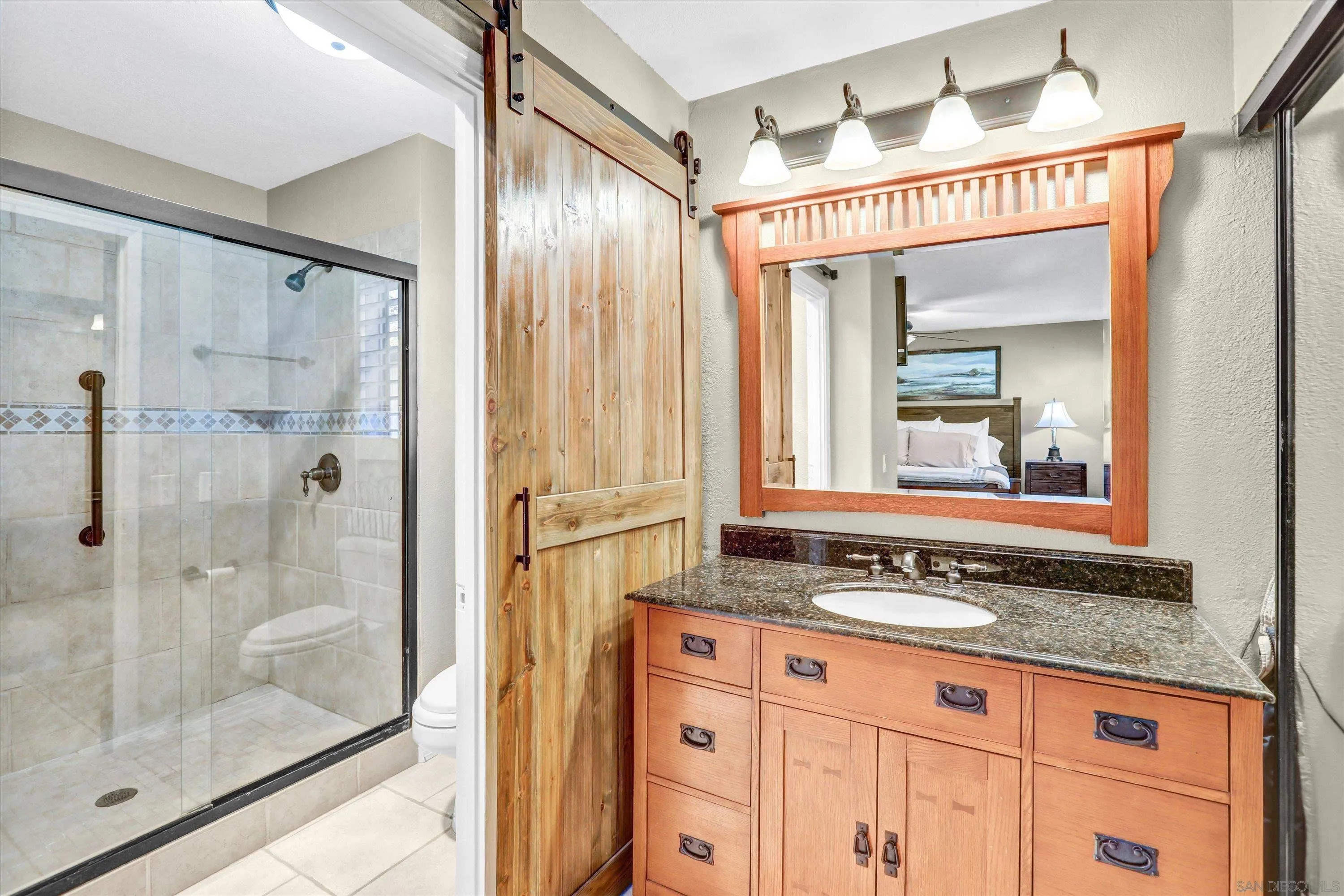 9448 Palomino Ridge Drive Lakeside, CA 92040 - Photo 22 of 35 a bathroom with a granite countertop sink mirror and shower