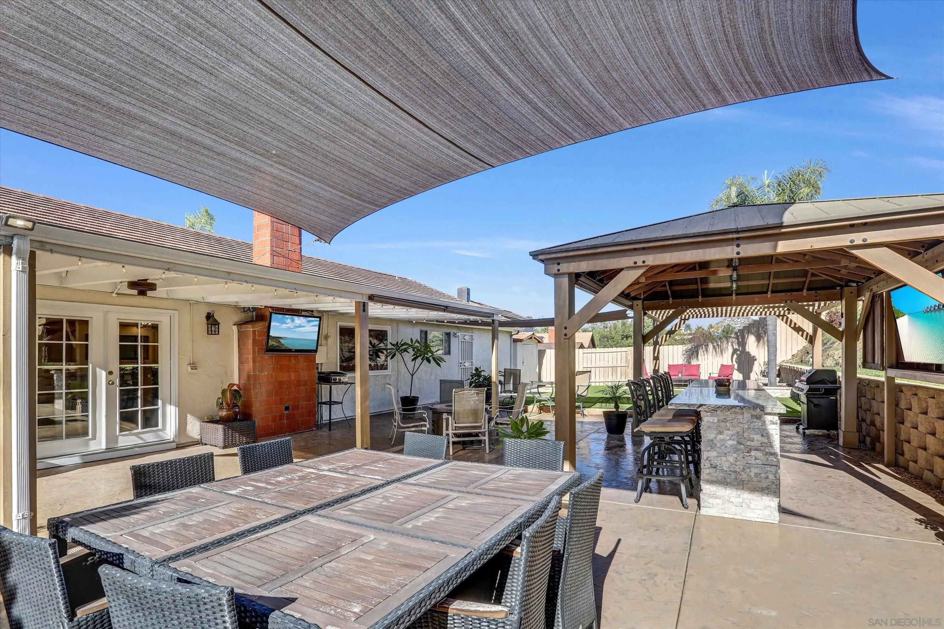 9448 Palomino Ridge Drive Lakeside, CA 92040 - Photo 26 of 35 a view of a patio with table and chairs under an umbrella
