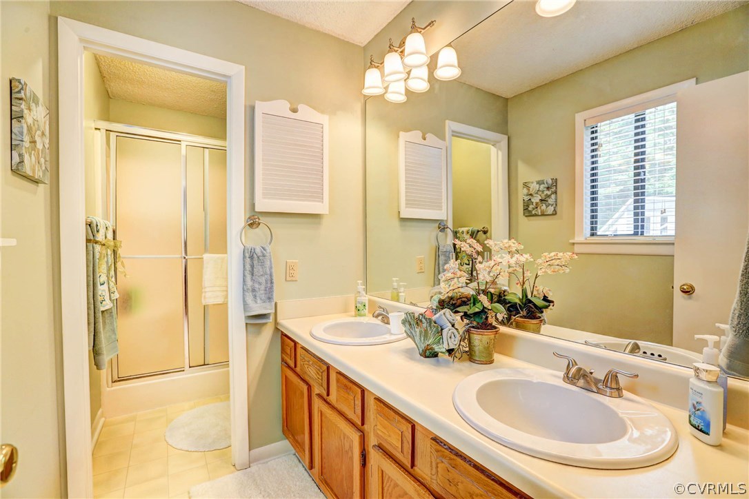 14117 Ridge Creek Road Midlothian, VA 23112 - Photo 13 of 24 a bathroom with a double vanity sink mirror and shower