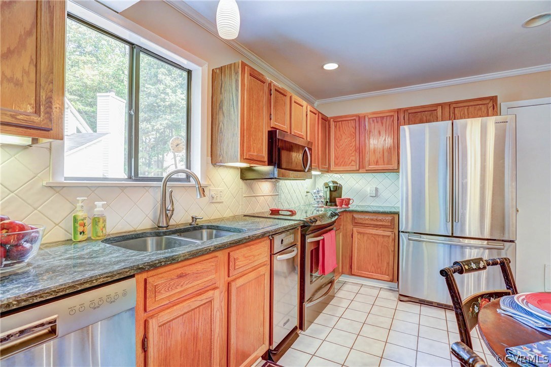 14117 Ridge Creek Road Midlothian, VA 23112 - Photo 8 of 24 a kitchen with granite countertop a sink and a refrigerator