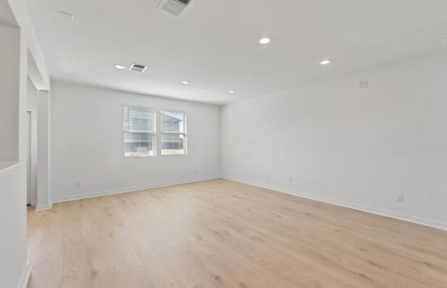 a view of hallway with stairs and wooden floor