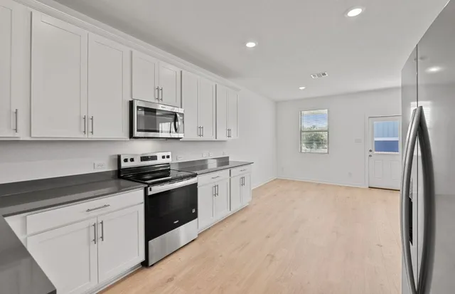 a kitchen with a sink stove and refrigerator