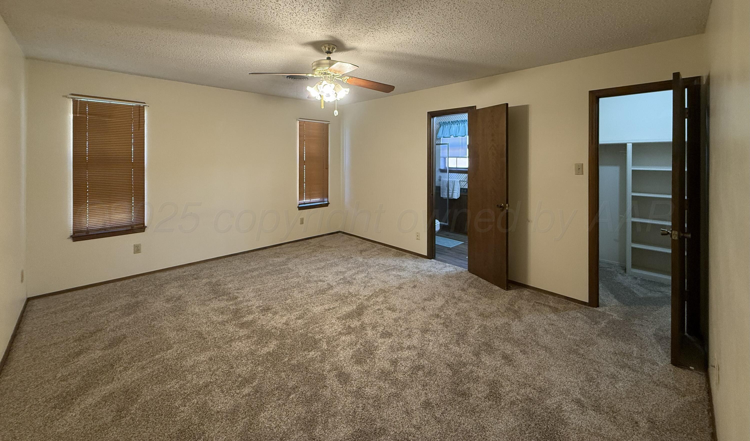 1525 North Nelson Street Pampa, TX 79065 - Photo 10 of 15 an empty room with windows and closet