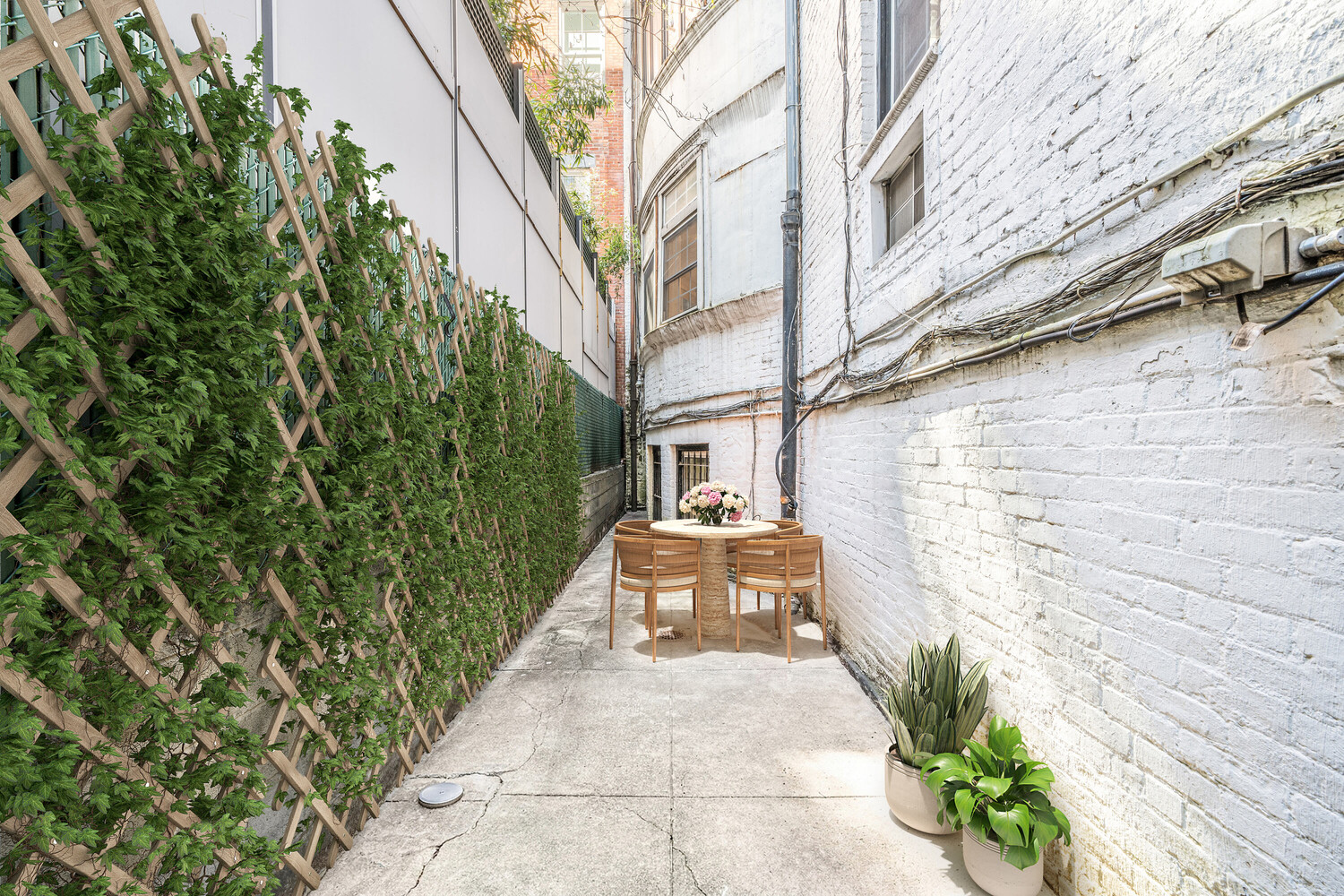 40 East 74th Street, Unit 1 Manhattan, NY 10021 - Photo 10 of 11 a view of a patio with table and chairs and potted plants
