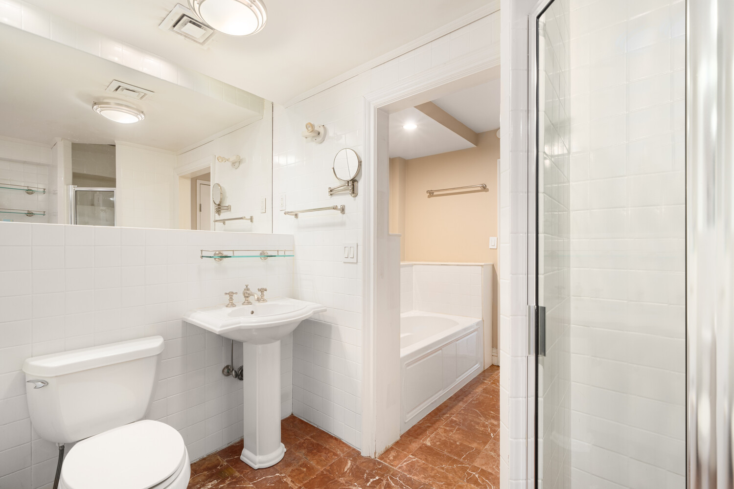 40 East 74th Street, Unit 1 Manhattan, NY 10021 - Photo 8 of 11 a bathroom with a sink a toilet and shower
