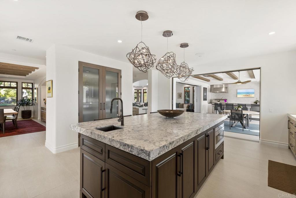 3226 Violet Ridge Encinitas, CA 92024 - Photo 17 of 54 a kitchen with a table and chairs in it