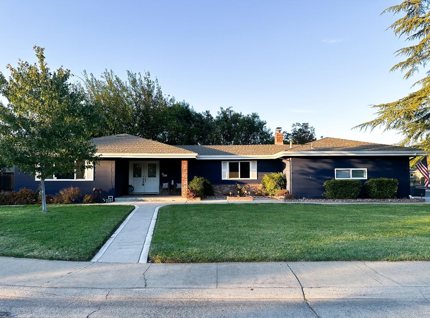 a front view of house with yard trampoline and green space