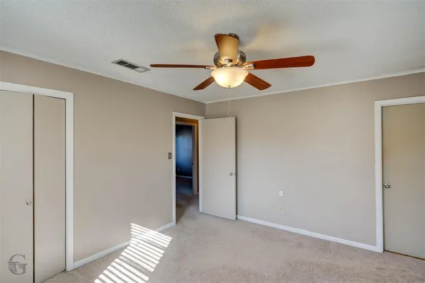 a view of room with a ceiling fan