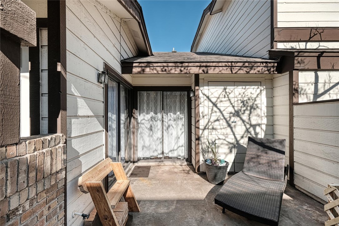 1748 Ohlen Road, Unit 74 Austin, TX 78757 - Photo 14 of 15 a view of a patio with table and chairs with wooden floor and fence