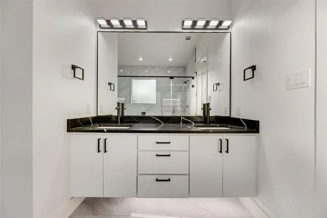 a bathroom with a sink a mirror and a light fixture