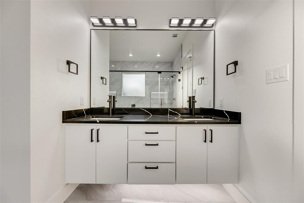 1651 East Overton Road Dallas, TX 75216 - Photo 11 of 21 a bathroom with a sink a mirror and a light fixture