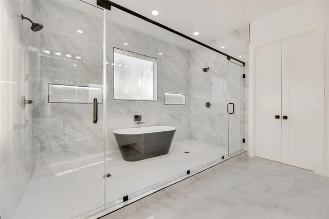 a bathroom with a bathtub and a shower