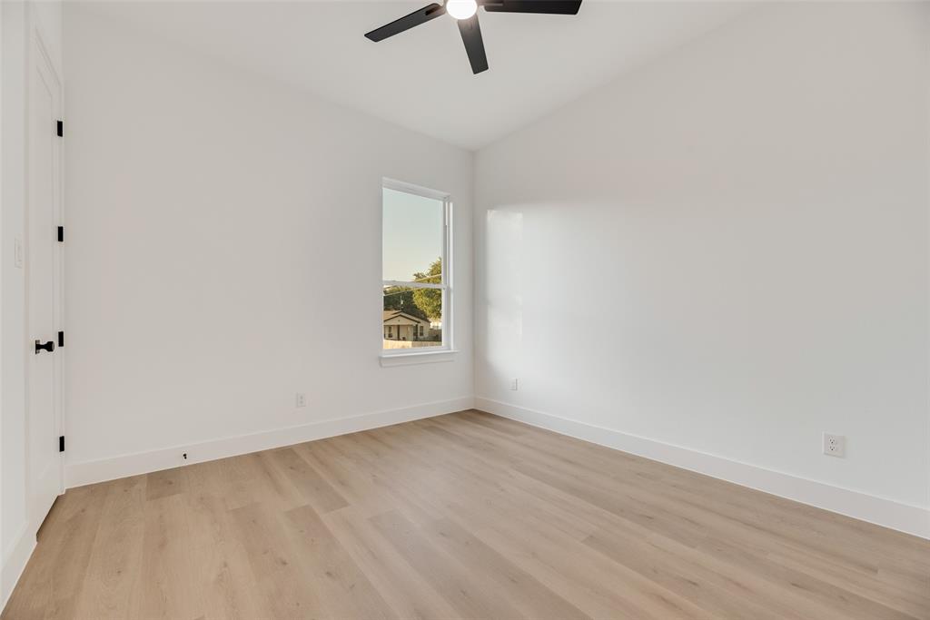 1651 East Overton Road Dallas, TX 75216 - Photo 16 of 21 an empty room with a window and ceiling fan