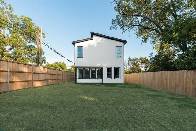 a view of a house with a yard and sitting area