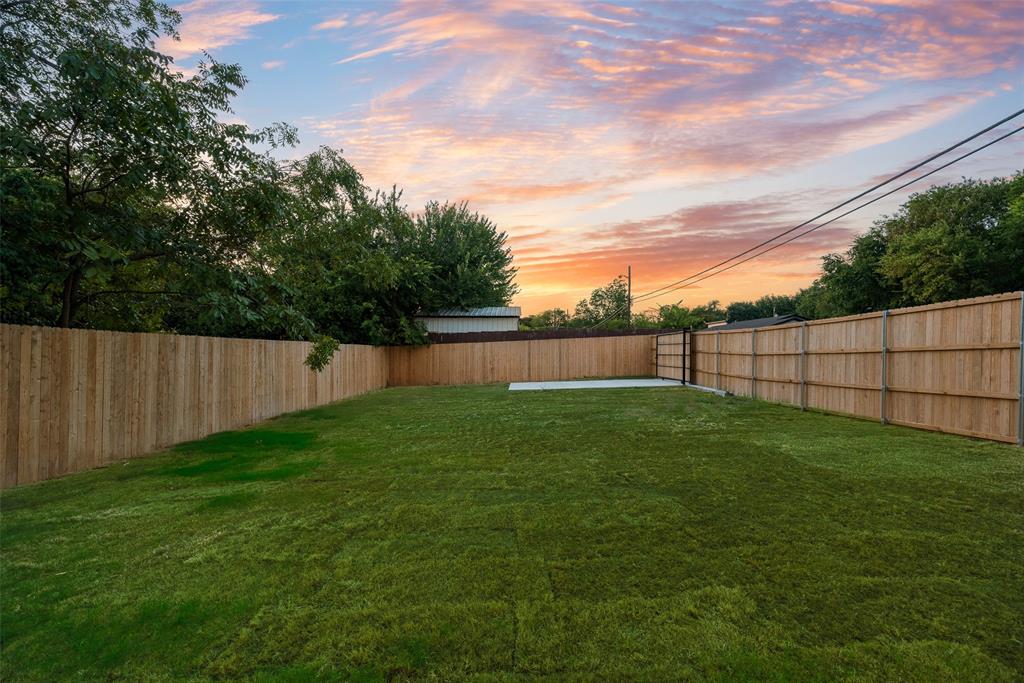 1651 East Overton Road Dallas, TX 75216 - Photo 20 of 21 a view of a backyard with a plants and trees