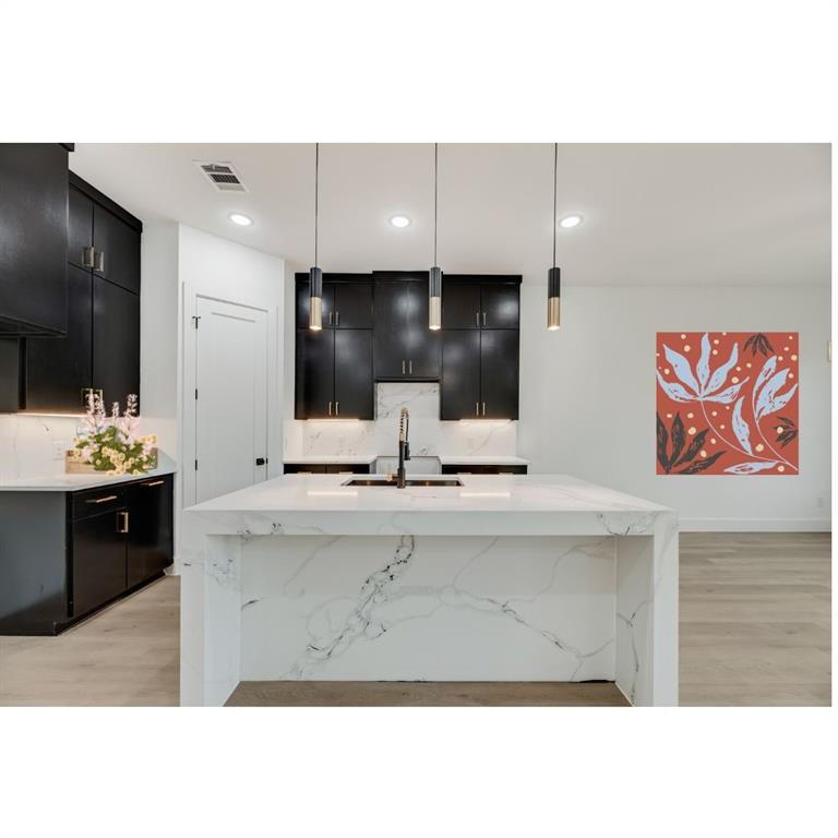 1651 East Overton Road Dallas, TX 75216 - Photo 7 of 21 a bathroom with a sink a large mirror and vanity