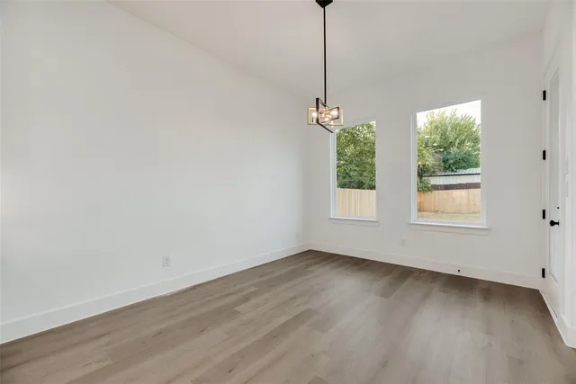 a view of an empty room with windows