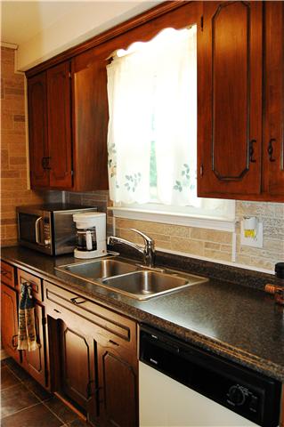 2231 Stokes Road Clarksville, TN 37043 - Photo 4 of 16 Kitchen has Rich Laminate Floors and a View of the Backyard