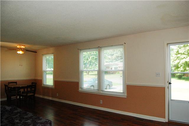2231 Stokes Road Clarksville, TN 37043 - Photo 8 of 16 Large Living Room has Rich Wood Laminate Flooring, Eat In Area, and Plenty of Natural Light