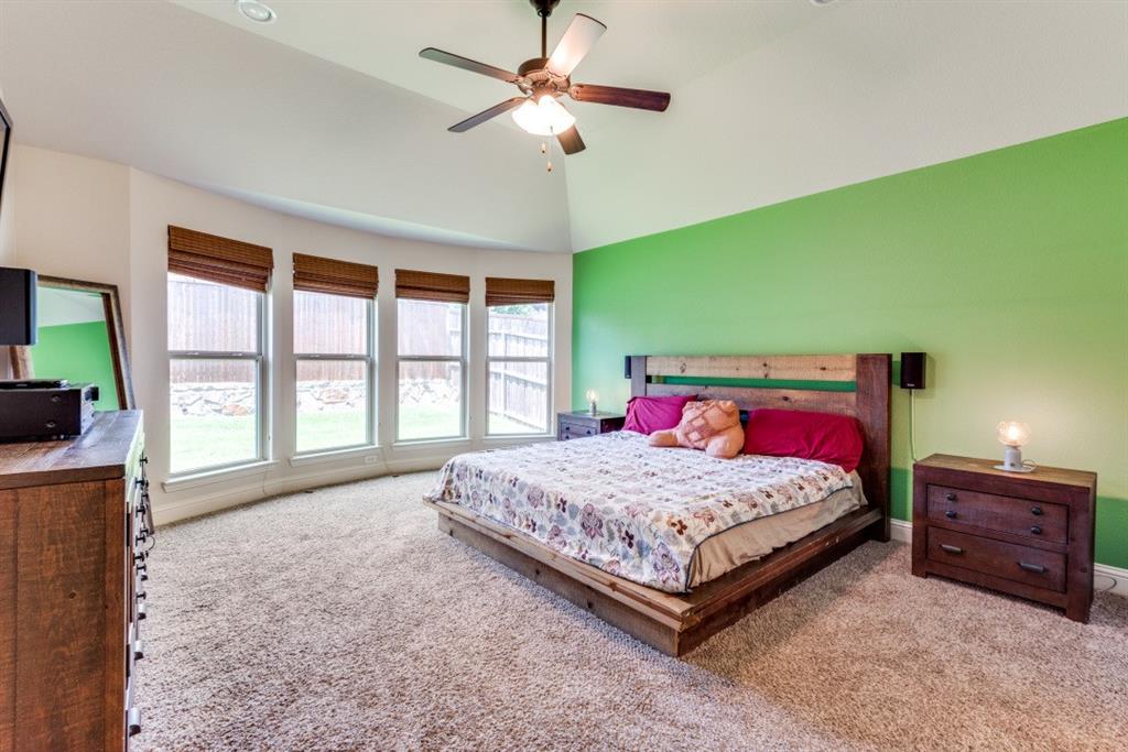 2364 Mare Road Carrollton, TX 75010 - Photo 19 of 25 a bedroom with a bed and a chandelier