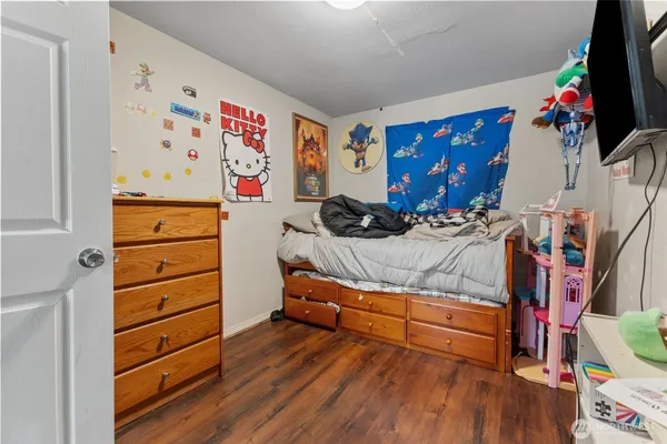 a bedroom with a bed and a dresser