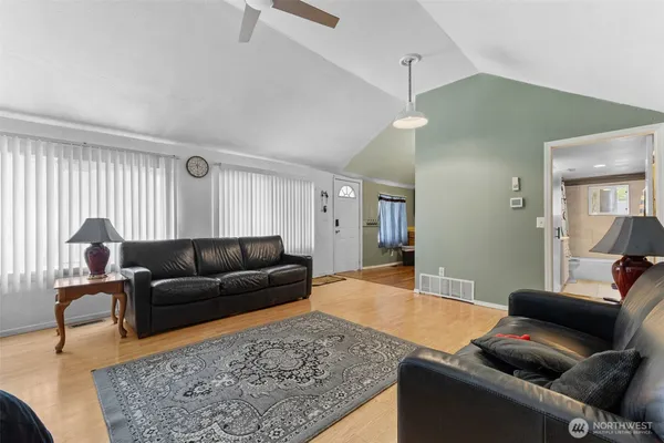 a living room with furniture and wooden floor
