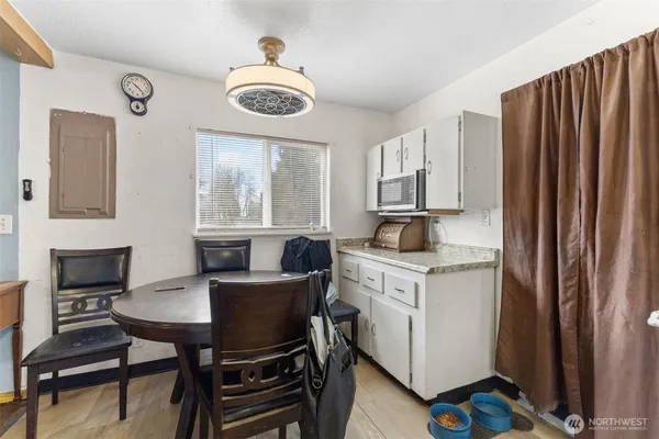 a kitchen with granite countertop a sink cabinets and wooden floor