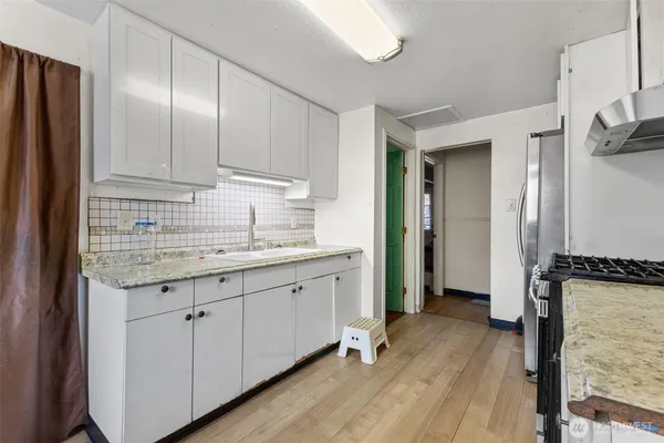 a kitchen with a refrigerator stove and sink