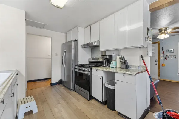 a kitchen with lots of counter top space and stainless steel appliances