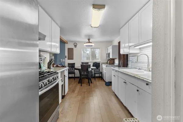 a bathroom with a sink double vanity mirror and a bathtub