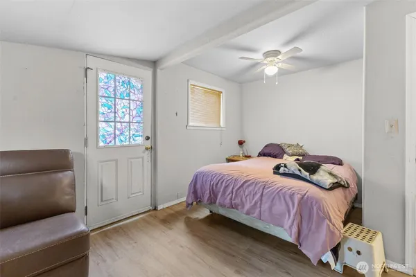 a bedroom with a bed and flat screen tv