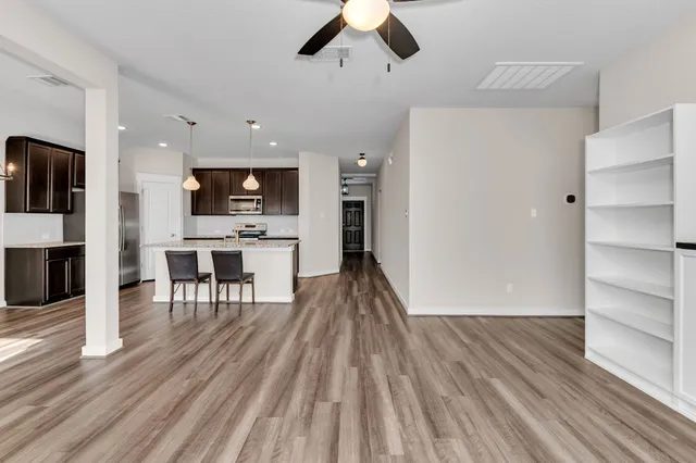 a view of kitchen with sink microwave and refrigerator