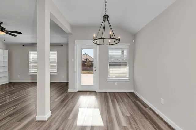 an empty room with closet and a ceiling fan